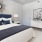a bedroom with a fan and a bed