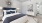a bedroom with a fan and a bed