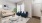 a living room with a couch and a fan