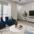 a living room with a blue couch and a television