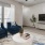 a living room with a blue couch and a television