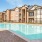 a swimming pool in front of a large building